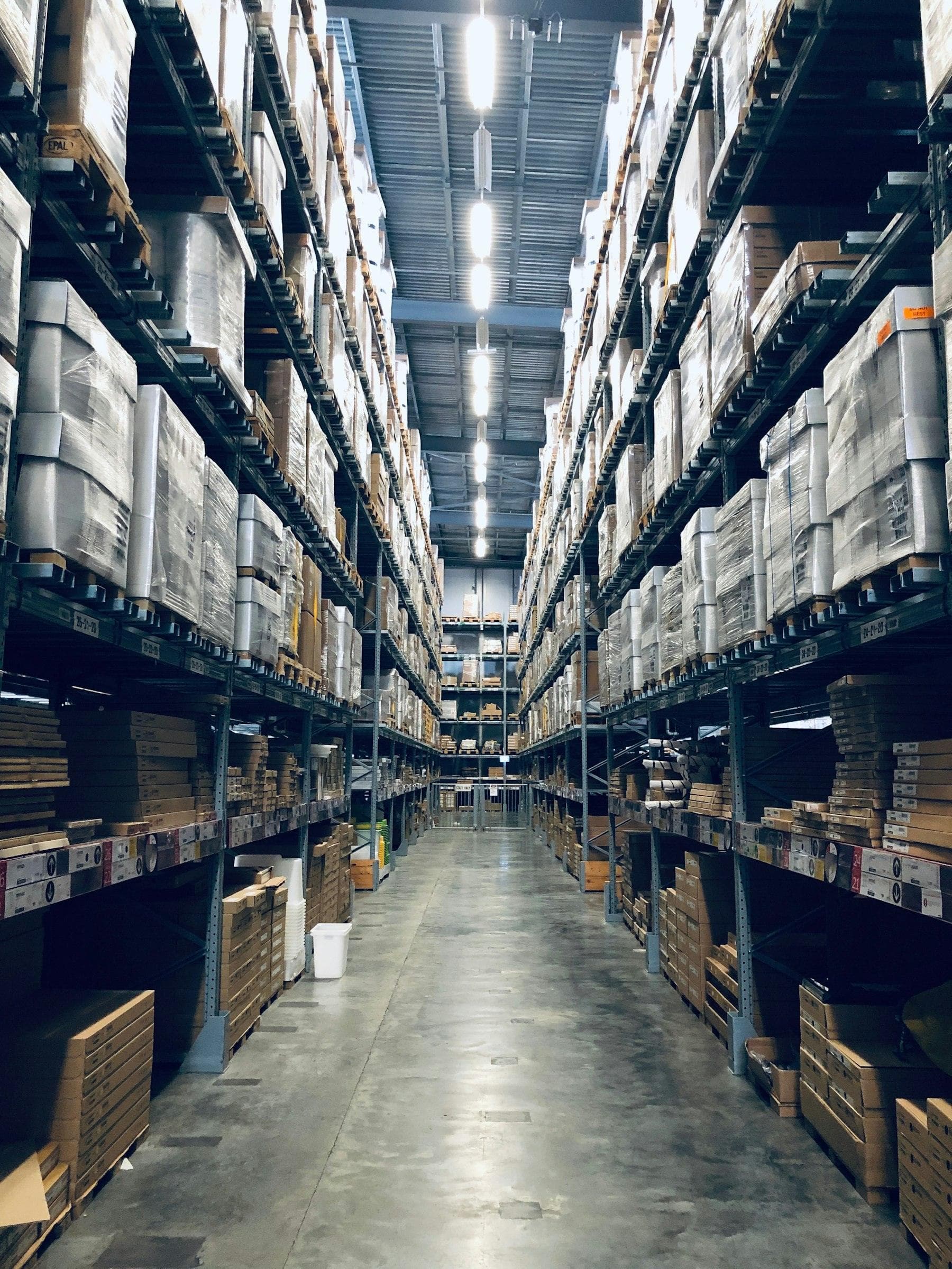 Long aisles of stocked shelves in a distribution warehouse