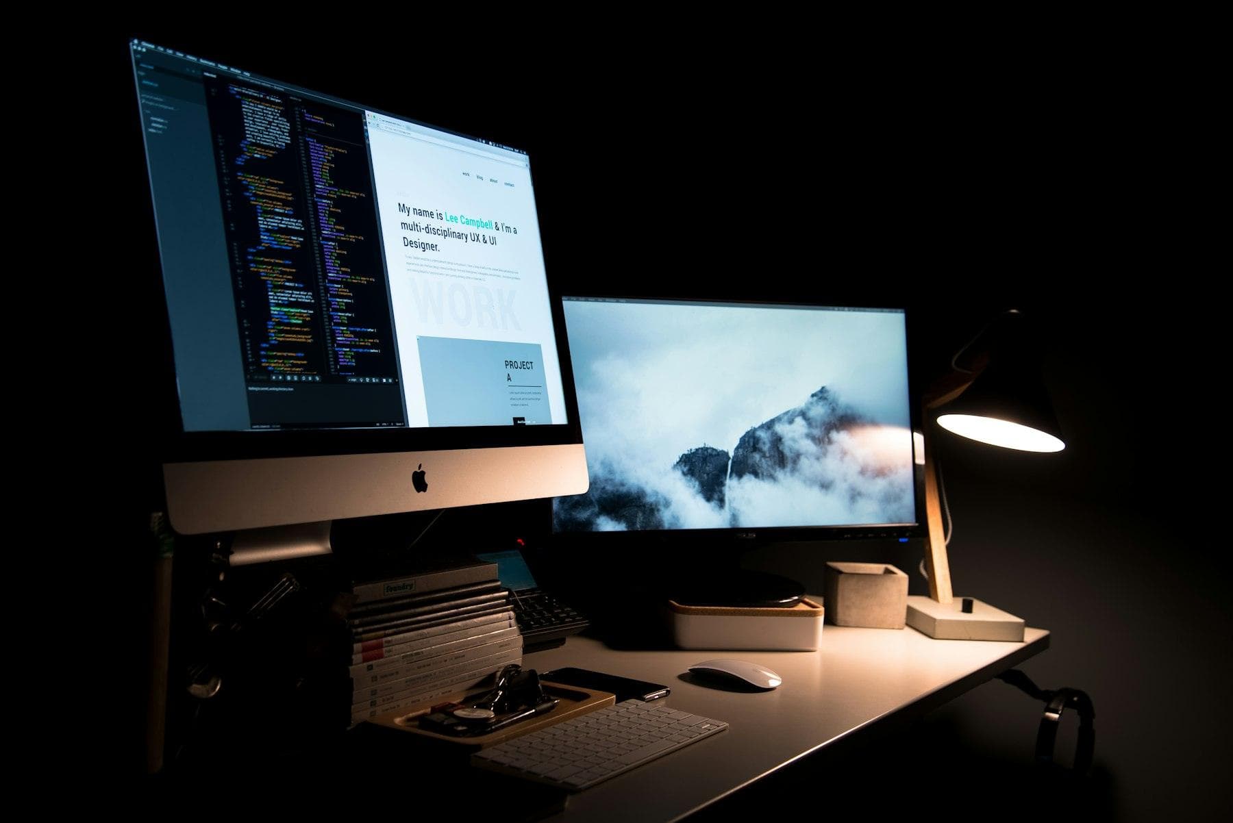 Desk with code on screen lit by a lamp at night