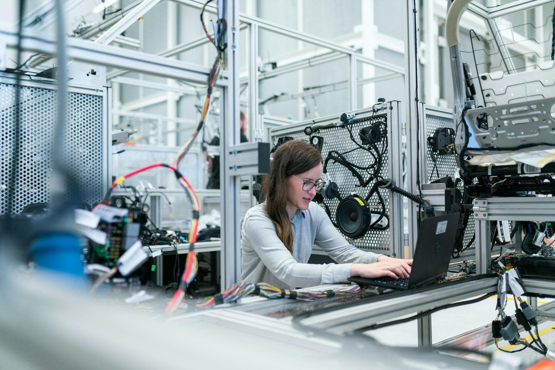 Engineer working at a laptop in an industrial test lab