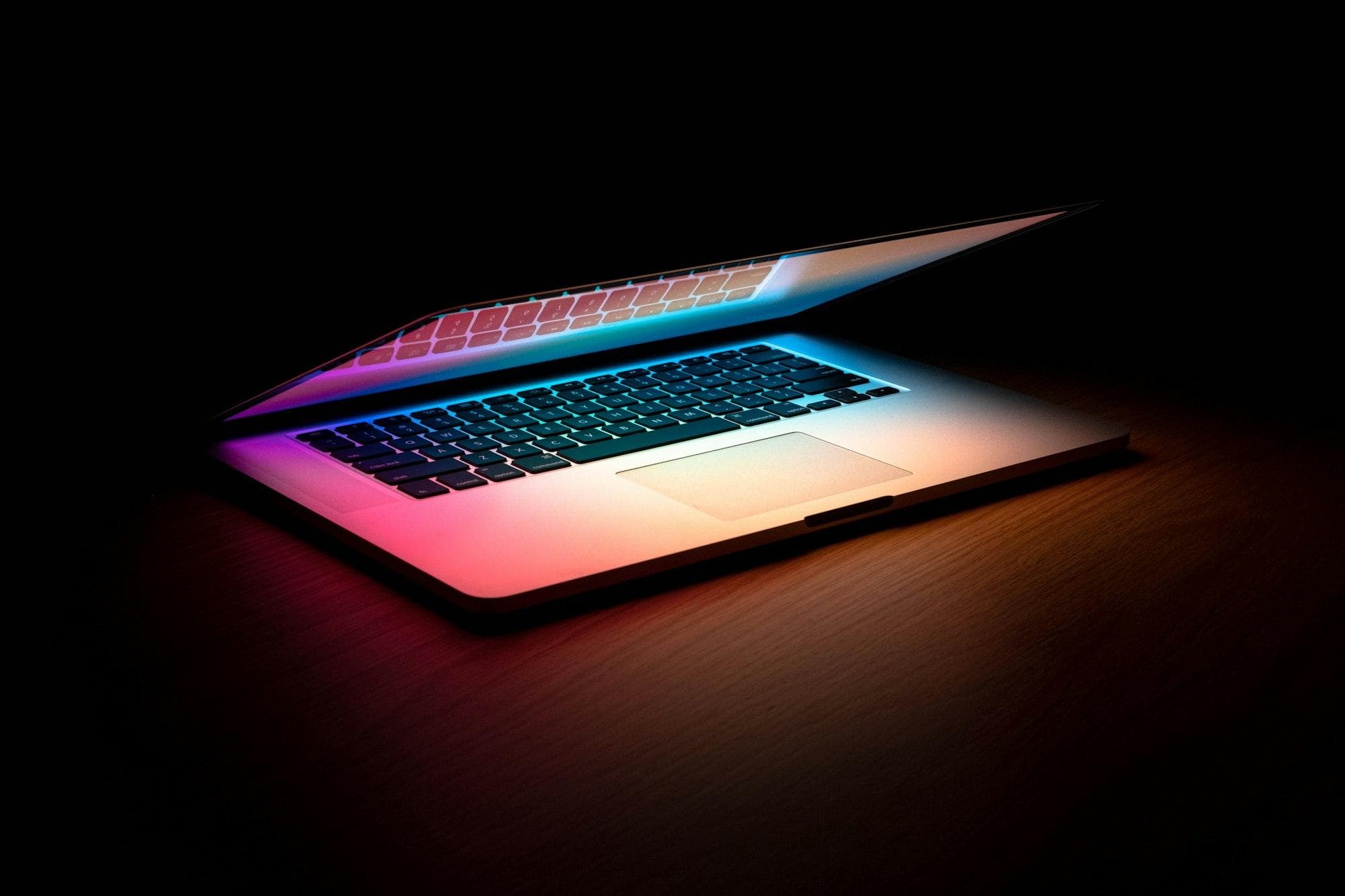 Laptop glowing in a dark room