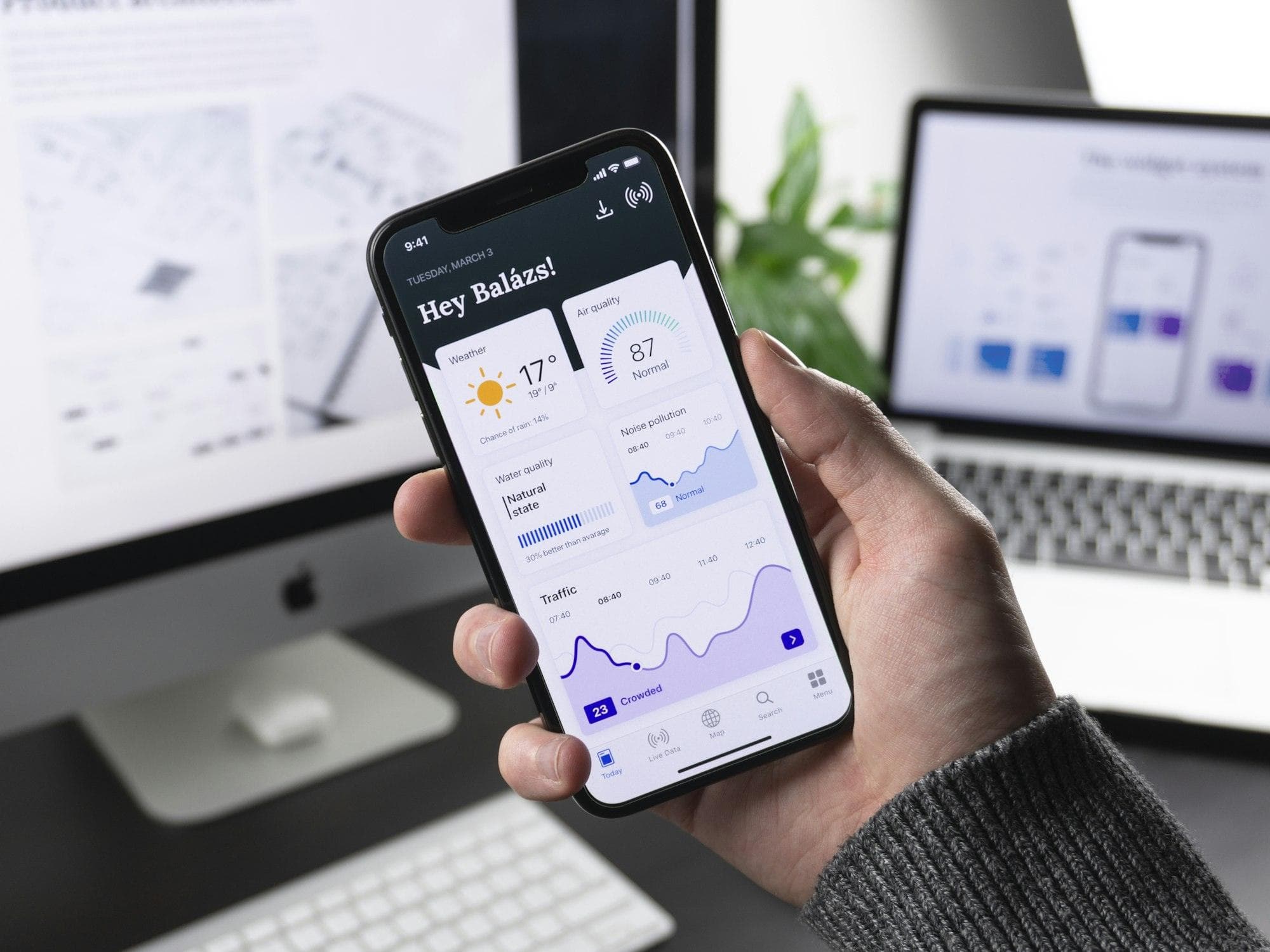 Hand holding a phone running a mobile app